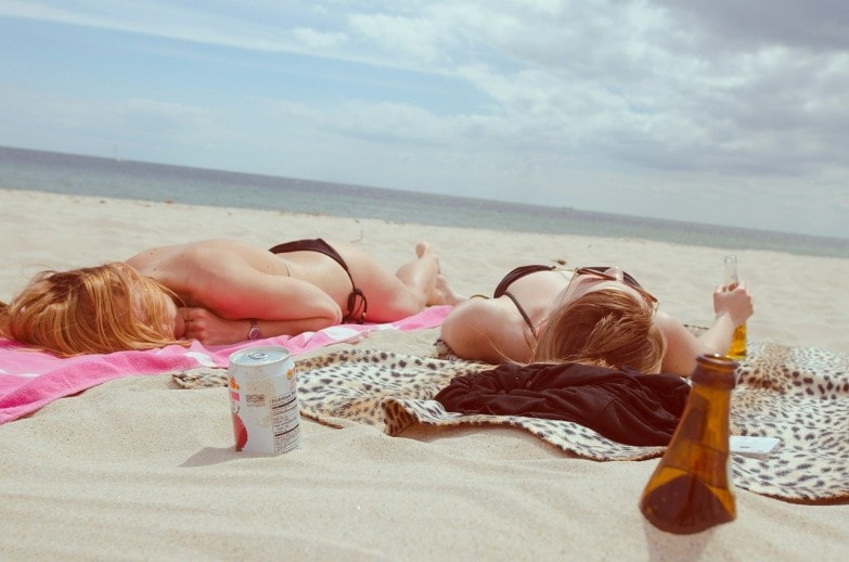 chicas tomando el sol con acelerador del bronceado